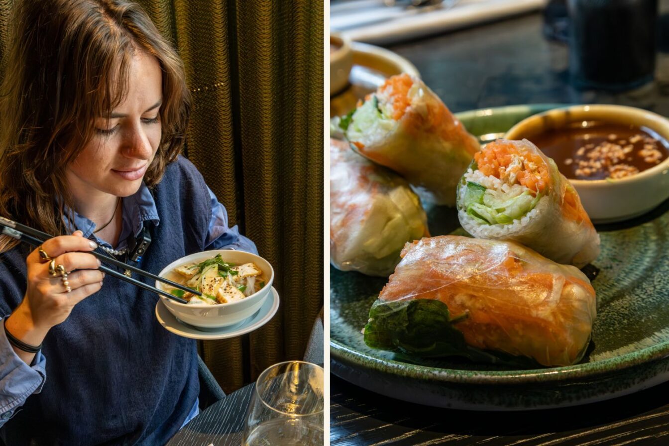 Person isst vietnamesische Pho-Suppe mit Tofu, daneben frische Sommerrollen mit Gemüse und Dip auf einem grünen Keramikteller im Vina Graz.