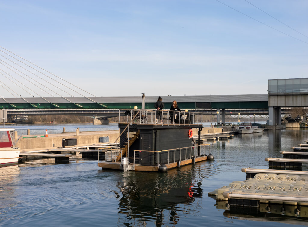 eine schwimmende Sauna in Schwarz auf der Donau