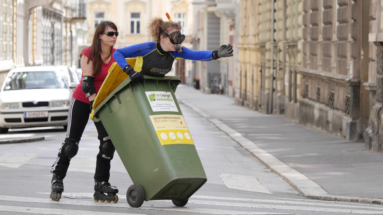 Mensch schiebt anderen Menschen in Mülltonne - Wiener Fotomarathon