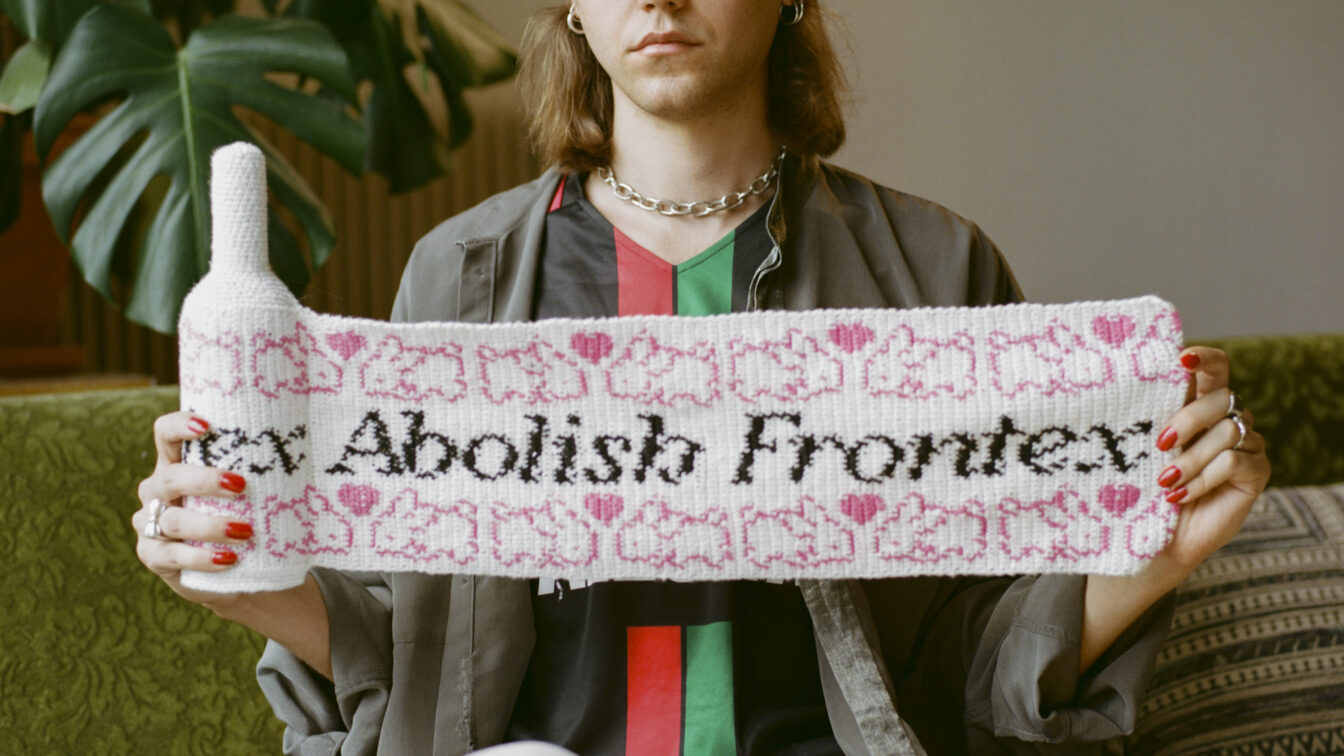 Eine Person auf einem Sofa, die eine Flasche mit Strickgewand trägt