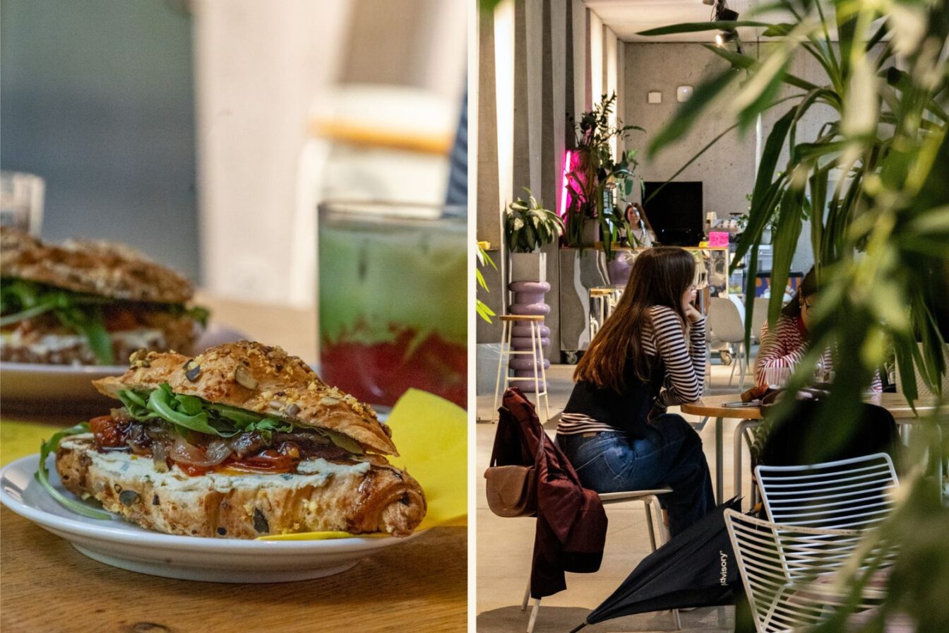 Frisches Croissant-Sandwich mit Gemüse und Käse bei Nude, einem lebhaften und modernen Café für Brunch in Zürich, mit gemütlicher Atmosphäre, Pflanzen und Gästen, die sich unterhalten.